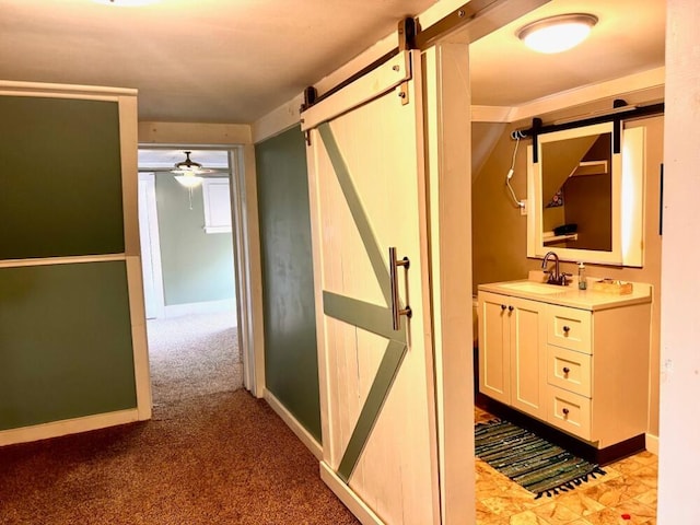 90 N Ave, Skowhegan, ME 04976 - corridor featuring a barn door, a sink, carpet floors, and baseboards