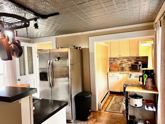 90 N Ave, Skowhegan, ME 04976 - kitchen featuring stainless steel appliances, an ornate ceiling, a baseboard radiator, stone finish flooring, and decorative backsplash
