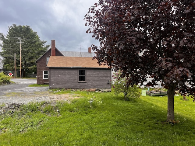 90 N Ave, Skowhegan, ME 04976 - view of home's exterior with a lawn and a chimney