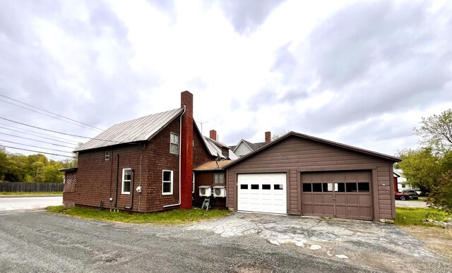 90 N Ave, Skowhegan, ME 04976 - view of property exterior with a chimney, an outbuilding, and a detached garage