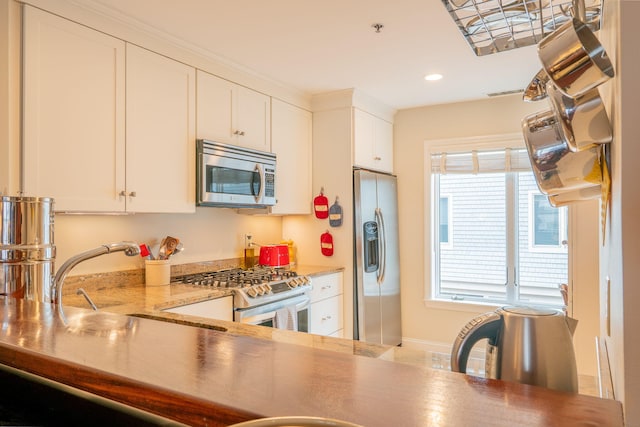 311 Chandlers Wharf Unit 311, Portland, ME 04101 - kitchen with appliances with stainless steel finishes, a sink, recessed lighting, white cabinetry, and light countertops