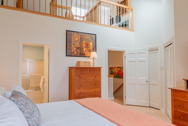 311 Chandlers Wharf Unit 311, Portland, ME 04101 - bedroom with a high ceiling, ensuite bathroom, and baseboards