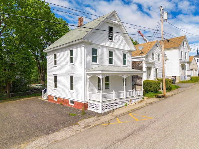31 Bath St, Bath, ME 04530 - view of front facade with covered porch, a chimney, and roof with shingles