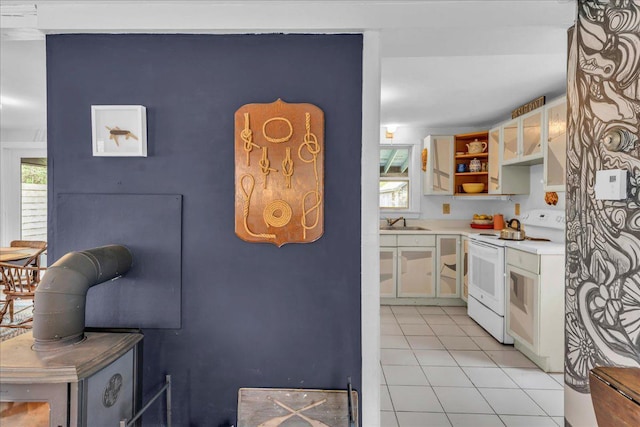 637 Falls Bridge Rd, Blue Hill, ME 04614 - kitchen with electric range, light countertops, light tile patterned flooring, open shelves, and plenty of natural light