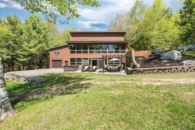 36 Sunset Dr, Saint Albans, ME 04971 - back of house featuring a hot tub, a patio, a garage, driveway, and a yard