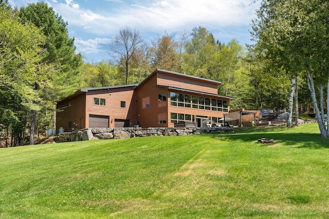 36 Sunset Dr, Saint Albans, ME 04971 - back of property with a garage and a yard