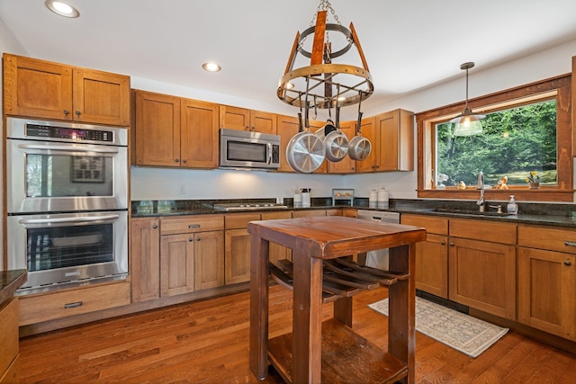 36 Sunset Dr, Saint Albans, ME 04971 - kitchen with stainless steel appliances, a sink, recessed lighting, brown cabinets, and dark wood-type flooring