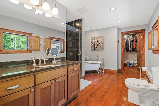 36 Sunset Dr, Saint Albans, ME 04971 - full bath featuring toilet, vanity, a freestanding bath, a walk in closet, and wood finished floors