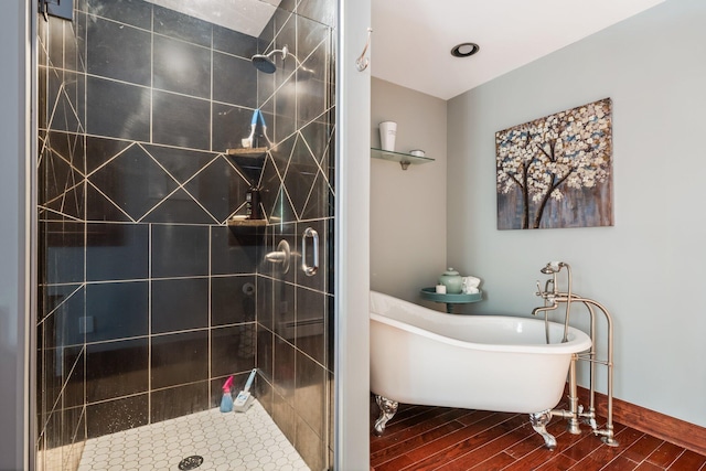 36 Sunset Dr, Saint Albans, ME 04971 - bathroom featuring a shower stall, a freestanding tub, and wood finished floors