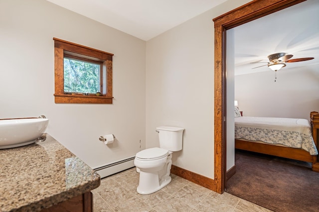 36 Sunset Dr, Saint Albans, ME 04971 - ensuite bathroom with baseboard heating, toilet, ceiling fan, baseboards, and vanity
