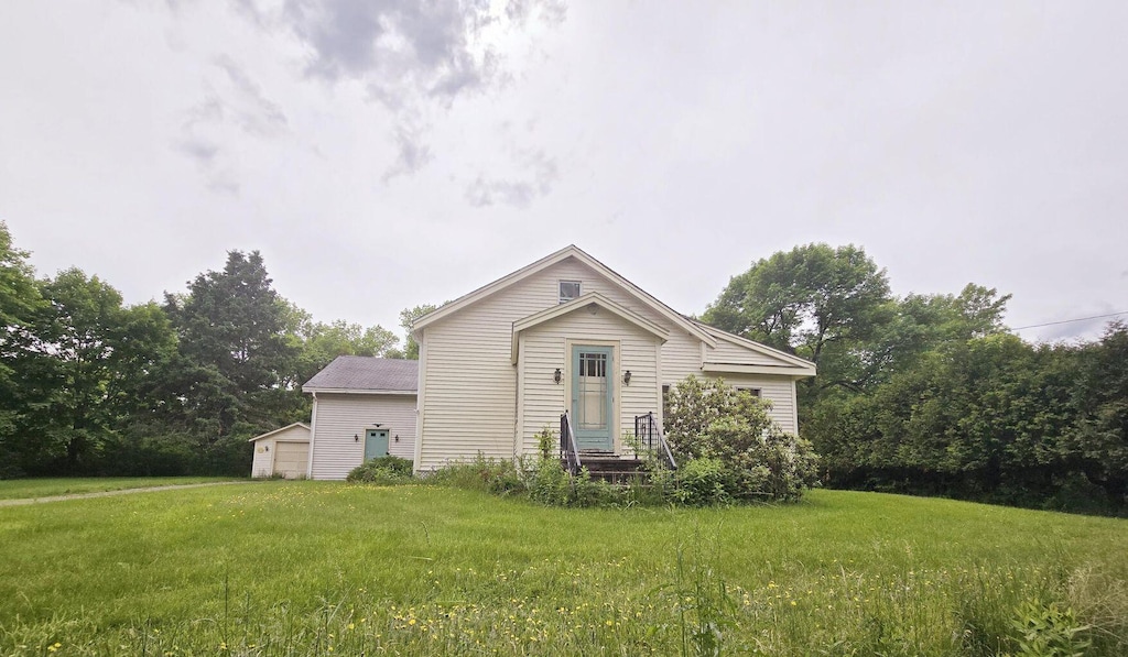 1132 College Ave, Old Town, ME 04468 - rear view of house with a yard, an outdoor structure, and a detached garage