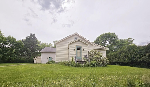 1132 College Ave, Old Town, ME 04468 - rear view of house with a yard, an outdoor structure, and a detached garage