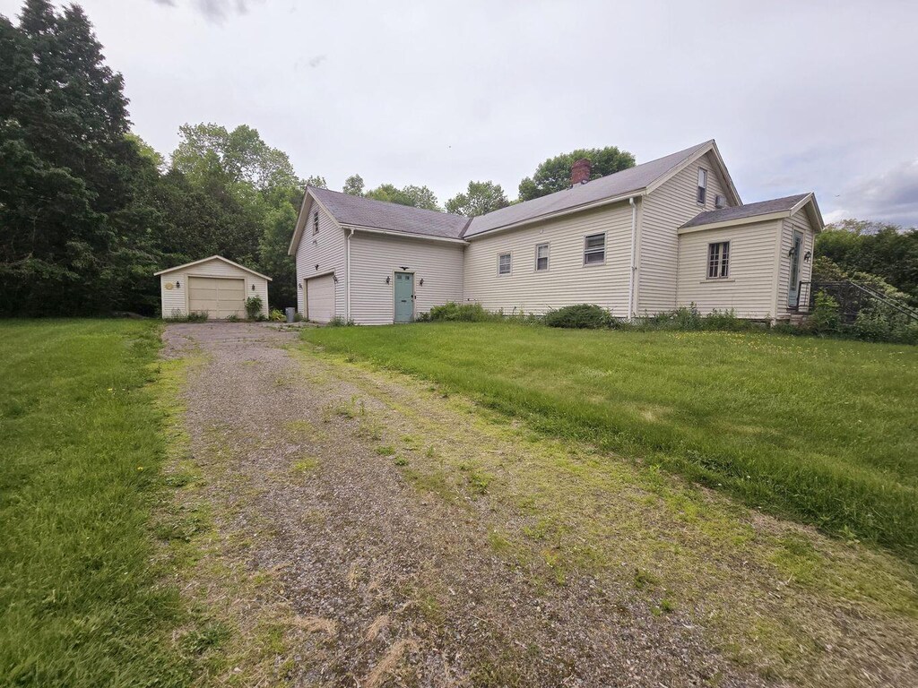 1132 College Ave, Old Town, ME 04468 - view of front of home with a front lawn and a chimney