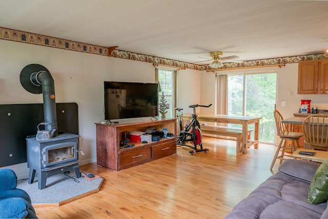 17 Easy St, Standish, ME 04084 - living room featuring plenty of natural light, light wood finished floors, ceiling fan, and a wood stove
