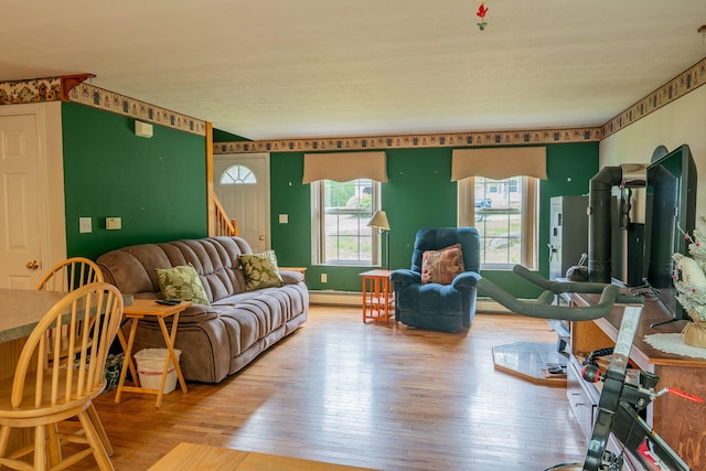 17 Easy St, Standish, ME 04084 - living room featuring wood-type flooring, a baseboard heating unit, and stairway