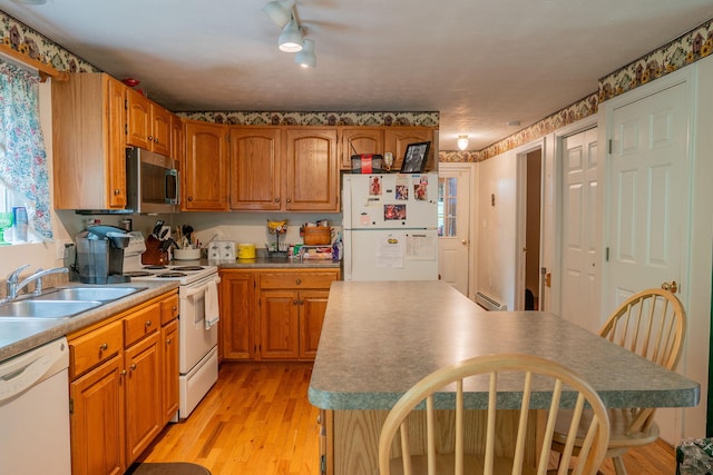 17 Easy St, Standish, ME 04084 - kitchen featuring white appliances, a sink, light wood-style flooring, brown cabinets, and a baseboard heating unit