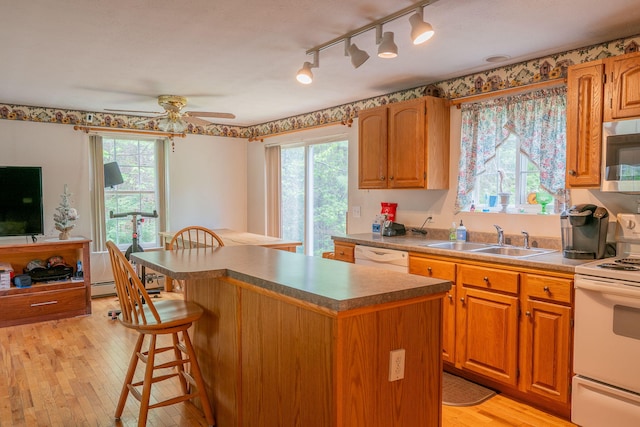 17 Easy St, Standish, ME 04084 - kitchen with white appliances, a sink, light wood-type flooring, a breakfast bar, and a ceiling fan