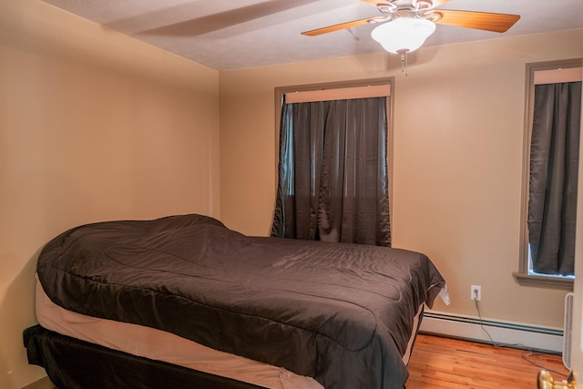 17 Easy St, Standish, ME 04084 - bedroom featuring a baseboard radiator, wood finished floors, and a ceiling fan