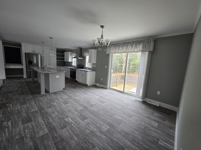 209 Sandy Acres Dr, Sullivan, ME 04664 - kitchen featuring gas range oven, wall chimney exhaust hood, stainless steel refrigerator with ice dispenser, a chandelier, and white cabinetry