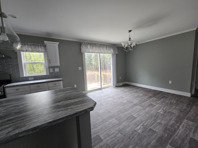 209 Sandy Acres Dr, Sullivan, ME 04664 - kitchen with a chandelier, dark countertops, healthy amount of natural light, ornamental molding, and dark wood finished floors