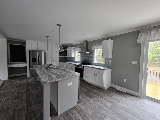 209 Sandy Acres Dr, Sullivan, ME 04664 - kitchen featuring range with gas stovetop, wall chimney exhaust hood, decorative backsplash, white cabinetry, and a kitchen island with sink