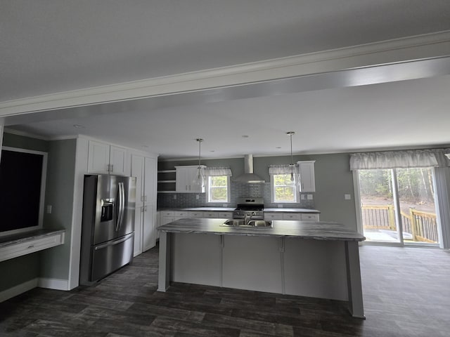 209 Sandy Acres Dr, Sullivan, ME 04664 - kitchen featuring appliances with stainless steel finishes, decorative backsplash, white cabinetry, a kitchen island with sink, and wall chimney exhaust hood