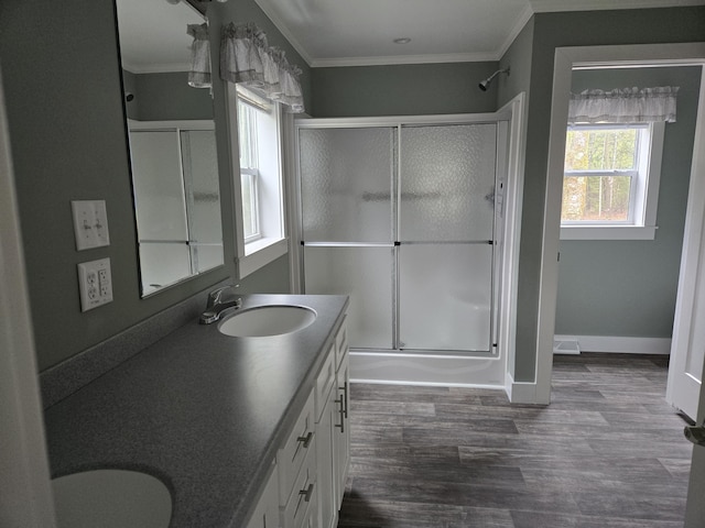 209 Sandy Acres Dr, Sullivan, ME 04664 - full bathroom with a shower with shower door, double vanity, crown molding, wood finished floors, and baseboards