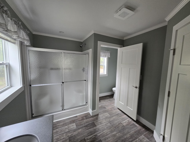 209 Sandy Acres Dr, Sullivan, ME 04664 - bathroom featuring toilet, a shower stall, wood finished floors, baseboards, and ornamental molding