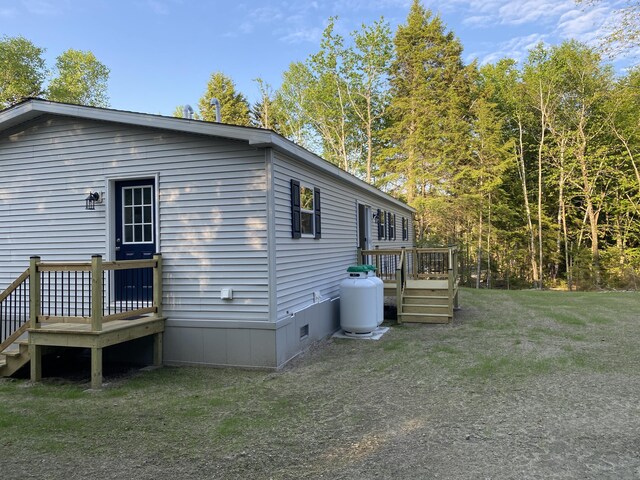 209 Sandy Acres Dr, Sullivan, ME 04664 - view of side of home with a wooden deck, crawl space, and a lawn