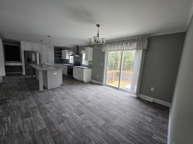 209 Sandy Acres Dr, Sullivan, ME 04664 - kitchen with stainless steel appliances, wall chimney exhaust hood, a chandelier, and white cabinets