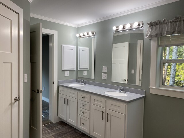 209 Sandy Acres Dr, Sullivan, ME 04664 - full bathroom featuring double vanity, crown molding, and wood finished floors