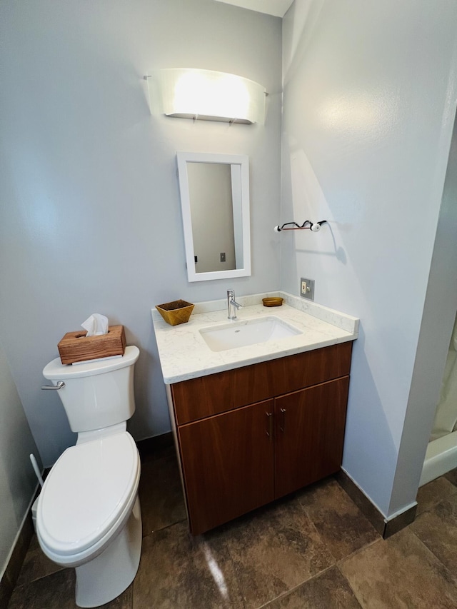 341 Ellsworth Rd, Blue Hill, ME 04614 - bathroom with vanity, toilet, baseboards, and stone finish floors