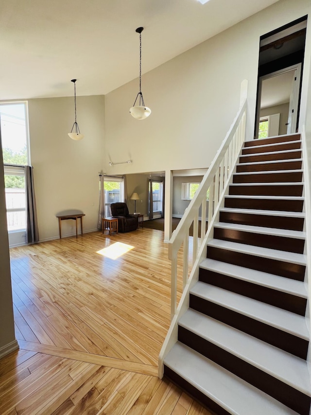 341 Ellsworth Rd, Blue Hill, ME 04614 - staircase featuring wood finished floors, high vaulted ceiling, and baseboards