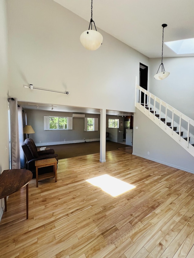 341 Ellsworth Rd, Blue Hill, ME 04614 - living room with a high ceiling, wood finished floors, and stairs