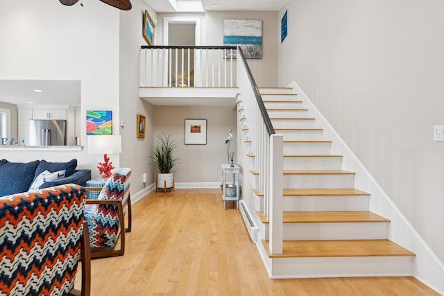 47 Ocean Ave Unit 6, Kennebunkport, ME 04046 - staircase featuring a baseboard heating unit, a high ceiling, hardwood / wood-style floors, recessed lighting, and a ceiling fan