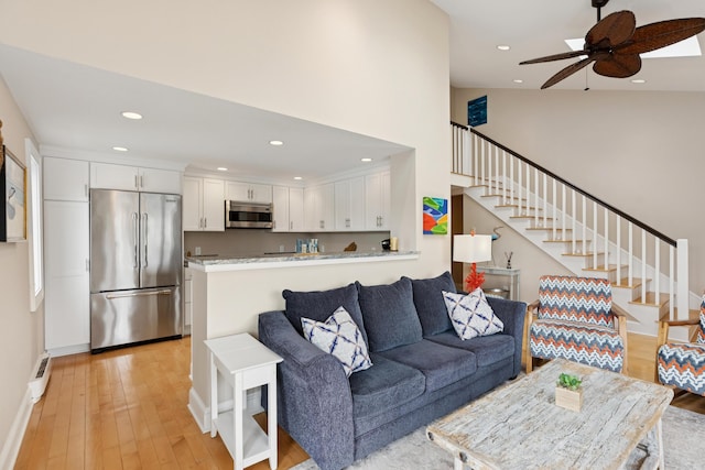 47 Ocean Ave Unit 6, Kennebunkport, ME 04046 - living room with stairway, light wood finished floors, a ceiling fan, recessed lighting, and a baseboard radiator