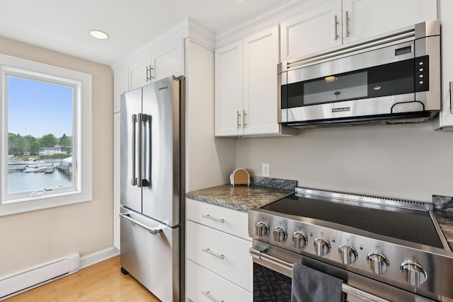 47 Ocean Ave Unit 6, Kennebunkport, ME 04046 - kitchen featuring stainless steel appliances, baseboard heating, light wood-type flooring, white cabinetry, and recessed lighting