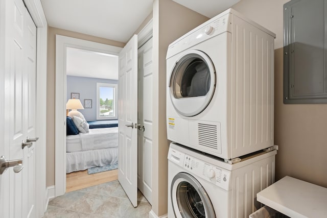 47 Ocean Ave Unit 6, Kennebunkport, ME 04046 - laundry room featuring stacked washer and clothes dryer and baseboards