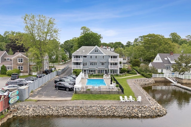 47 Ocean Ave Unit 6, Kennebunkport, ME 04046 - back of property with a fenced backyard, a balcony, uncovered parking, and a water view