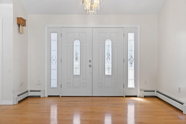 37 Longbow Ct, Auburn, ME 04210 - foyer entrance featuring a chandelier, light wood-style flooring, a baseboard radiator, and baseboards