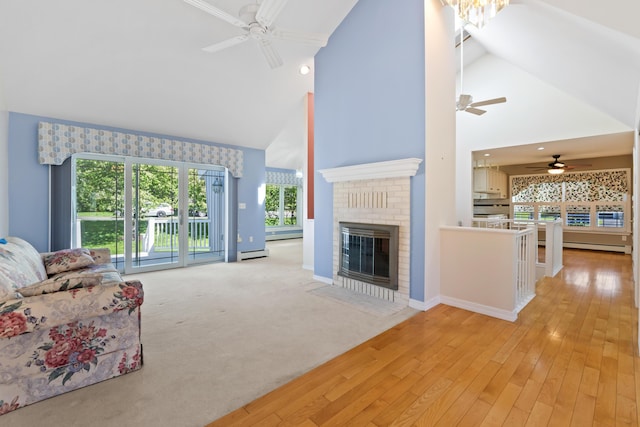37 Longbow Ct, Auburn, ME 04210 - living area with ceiling fan, high vaulted ceiling, a baseboard heating unit, baseboard heating, and a fireplace