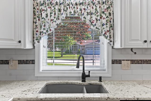 37 Longbow Ct, Auburn, ME 04210 - kitchen featuring a sink, white cabinetry, and backsplash