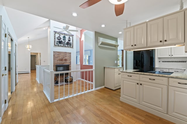 37 Longbow Ct, Auburn, ME 04210 - kitchen with black appliances, ceiling fan, light wood finished floors, light stone counters, and tasteful backsplash
