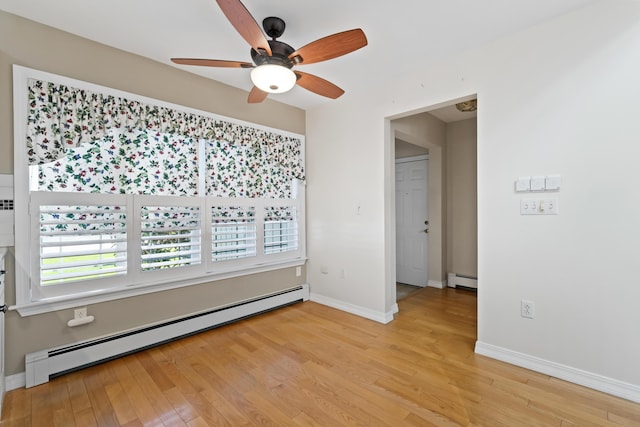 37 Longbow Ct, Auburn, ME 04210 - empty room with baseboard heating, ceiling fan, light wood-type flooring, and baseboards