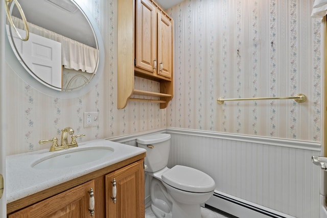 37 Longbow Ct, Auburn, ME 04210 - bathroom with a baseboard radiator, wallpapered walls, a wainscoted wall, vanity, and toilet