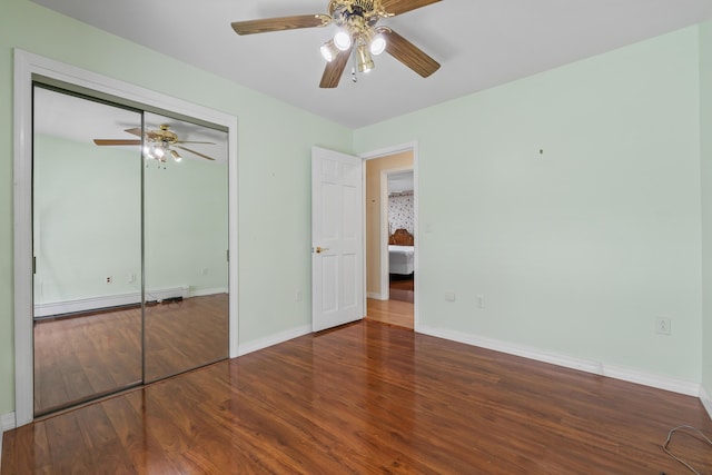 37 Longbow Ct, Auburn, ME 04210 - unfurnished bedroom with wood finished floors, baseboards, a closet, a ceiling fan, and a baseboard radiator