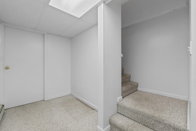 37 Longbow Ct, Auburn, ME 04210 - finished basement featuring carpet floors, stairway, a paneled ceiling, a baseboard radiator, and baseboards