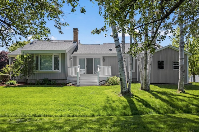 37 Longbow Ct, Auburn, ME 04210 - view of front of property with a wooden deck, a front yard, a chimney, roof with shingles, and an outdoor structure