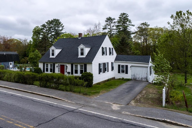 57 Bow St, Freeport, ME 04032 - cape cod house with asphalt driveway, an outdoor structure, a chimney, an attached garage, and a shingled roof