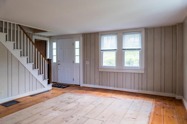 57 Bow St, Freeport, ME 04032 - entryway featuring hardwood / wood-style flooring, stairs, baseboards, and wooden walls